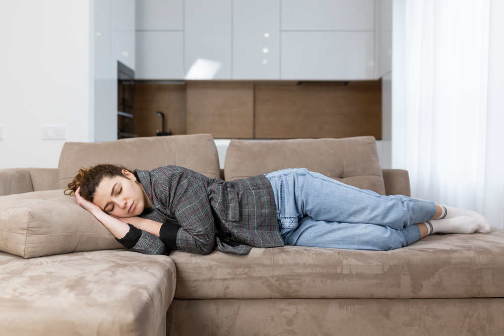 woman-taking-a-nap-on-her-sofa-after-a-long-day