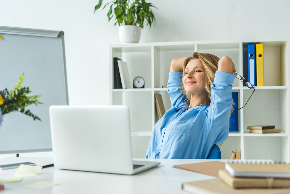 dutch-business-woman-happy-sitting-back-for-break-at-desk
