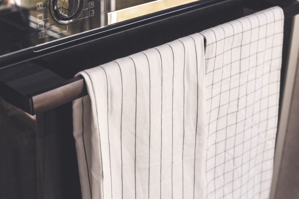 photo-white-kitchen-towels-hanging-on-an-oven-handle