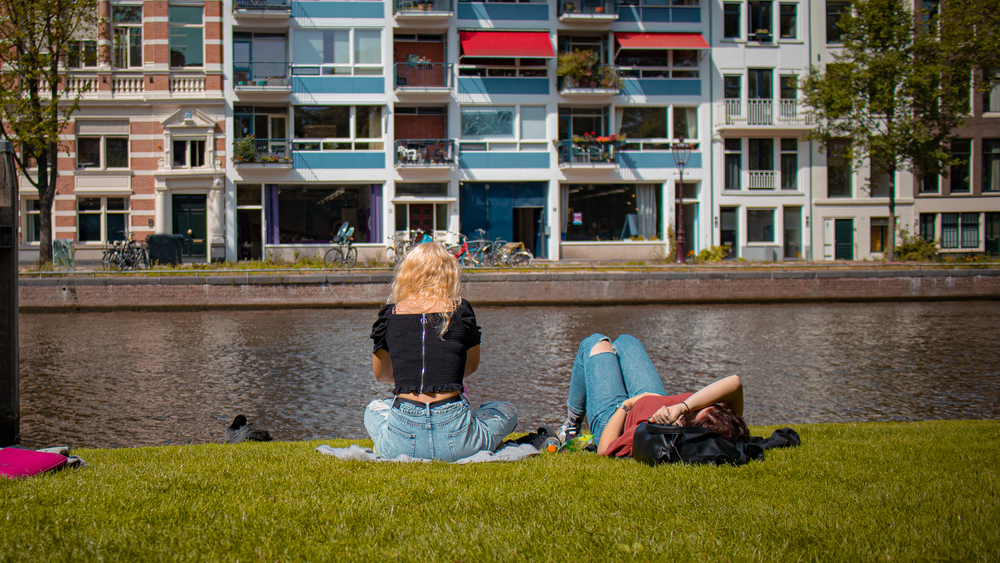 photo-of-two-Dutch-women-relaxing-in-amsterdam-by-canal